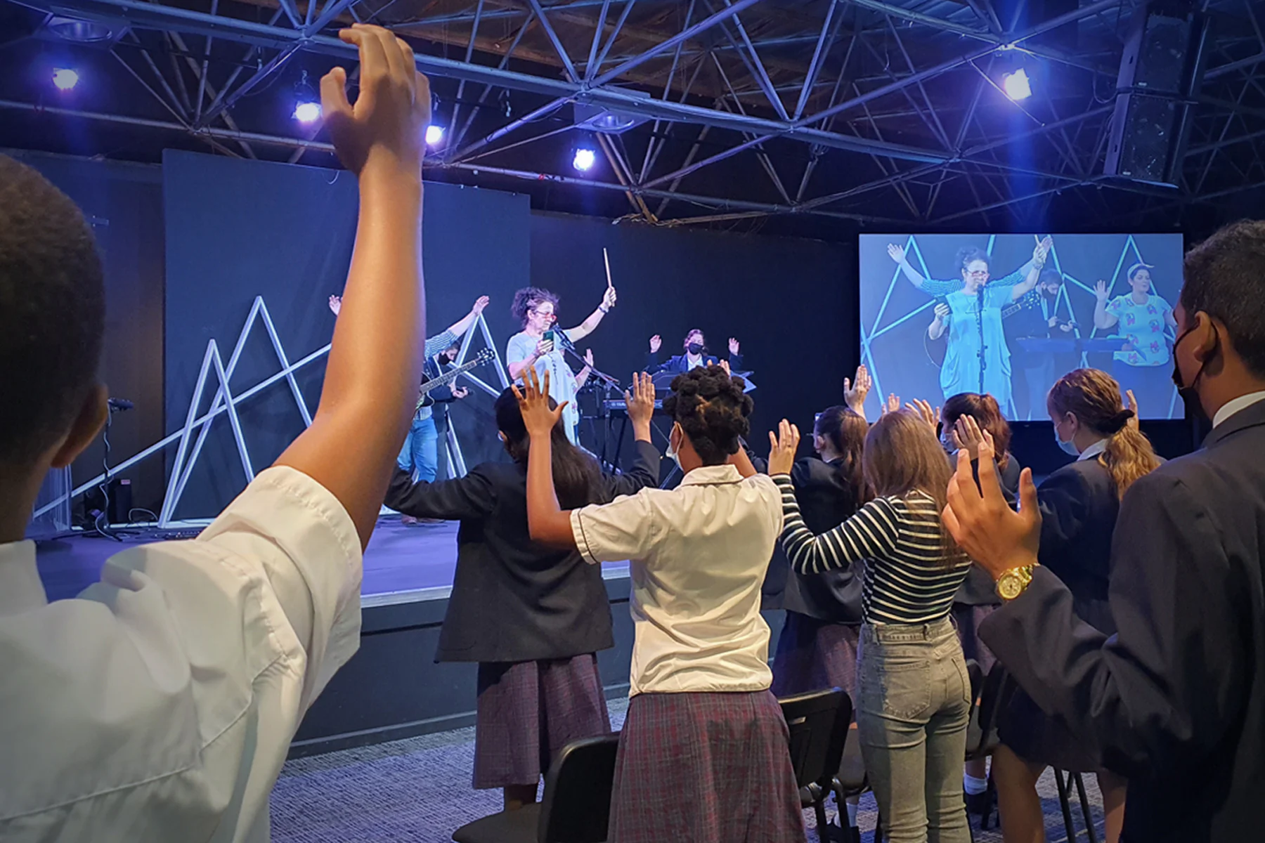 Learners and staff worshipping together at His Church School